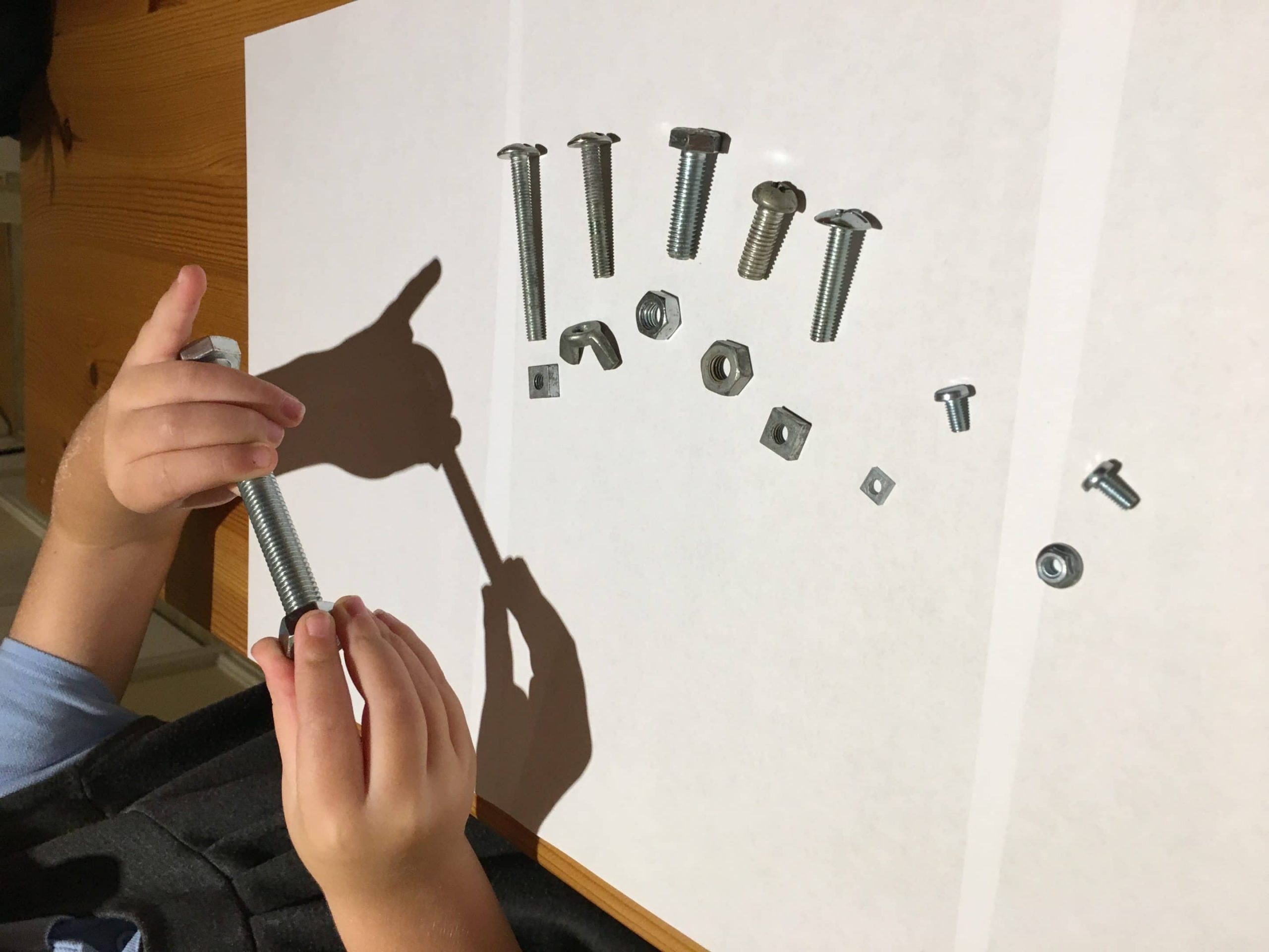 Child playing with nuts and bolts