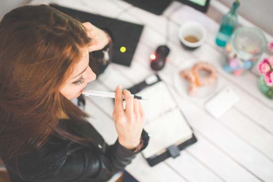 Woman writing at desk