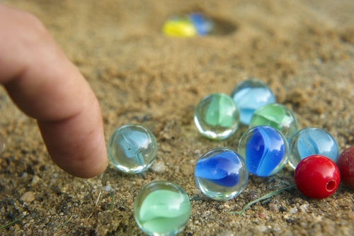 Photo of Marbles in Sand