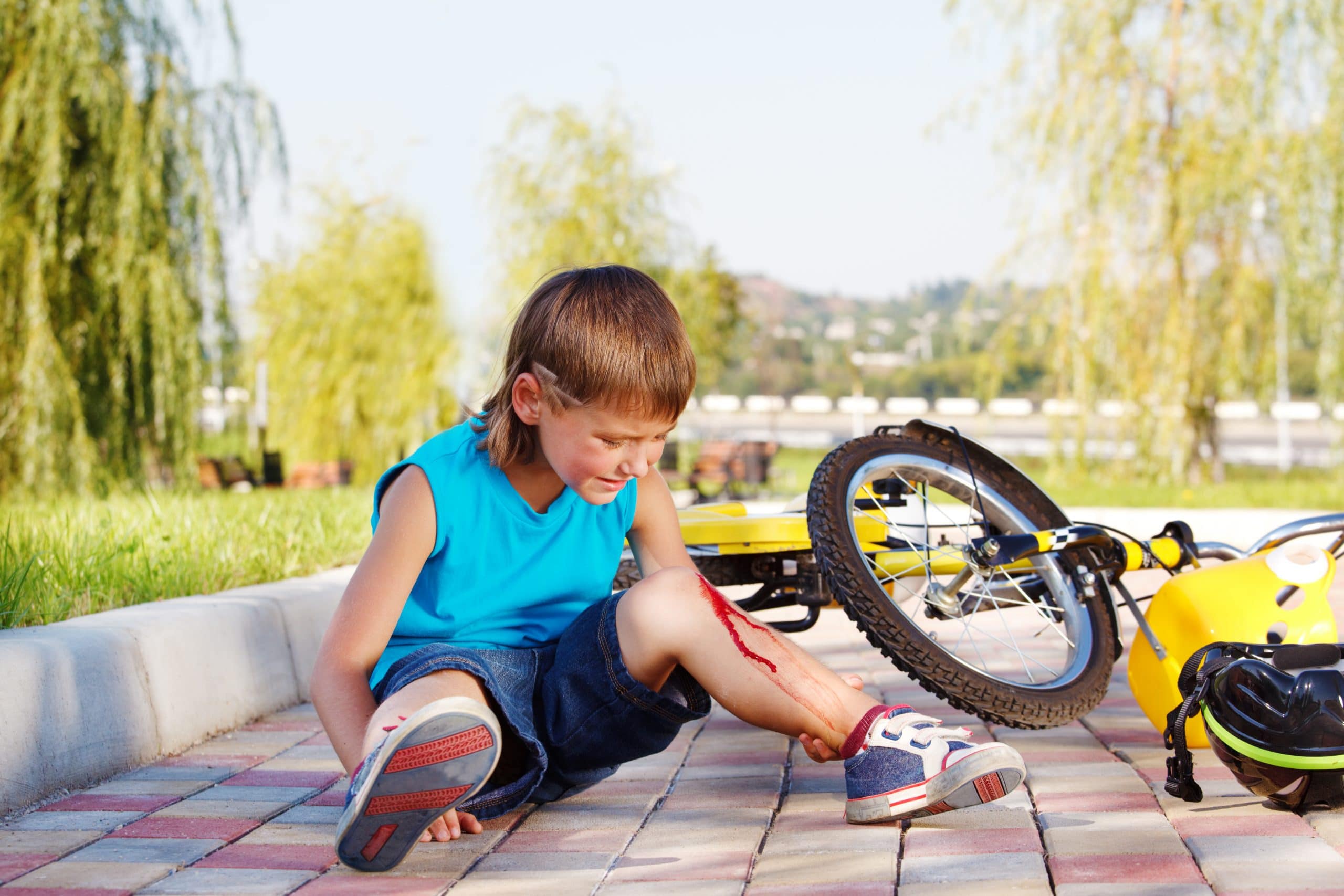 Boy crying after falling off bike